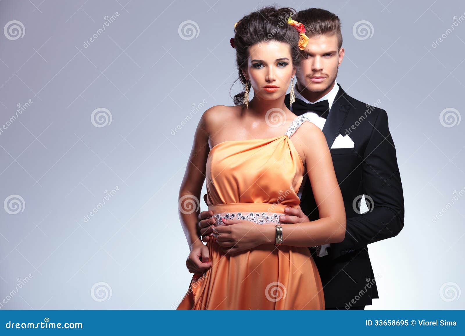 Fashion Couple with Man Behind Woman Stock Image - Image of bowtie