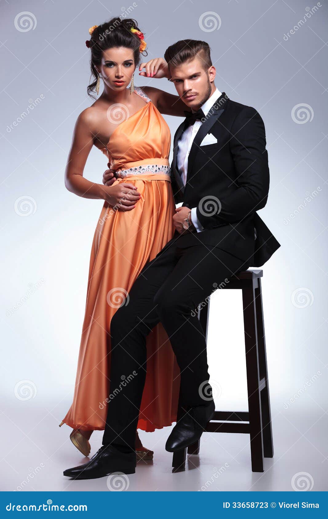 Fashion Couple With Man On Chair Stock Photos - Image 