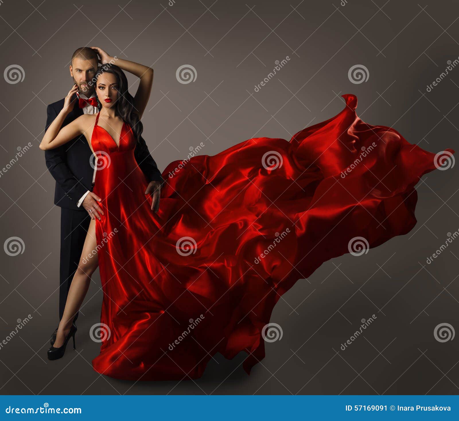 fashion couple portrait, woman red dress, man in suit, long cloth