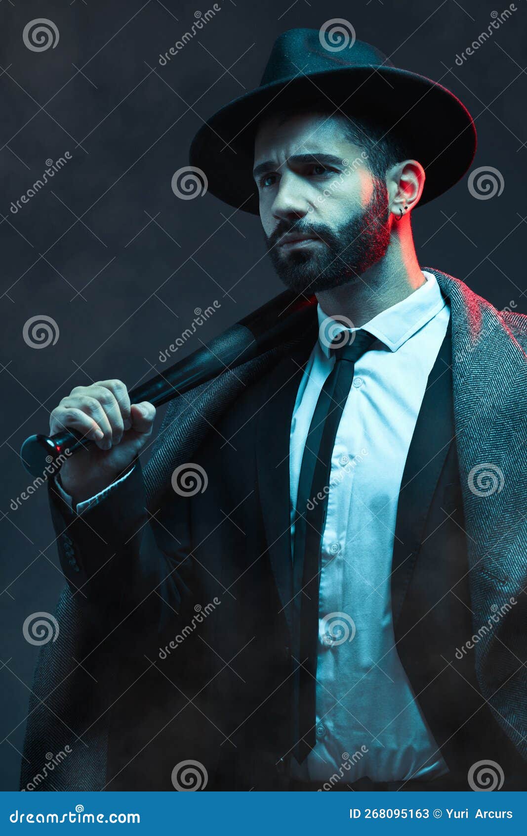 Mafia, fashion and mystery man in a suit isolated on a dark