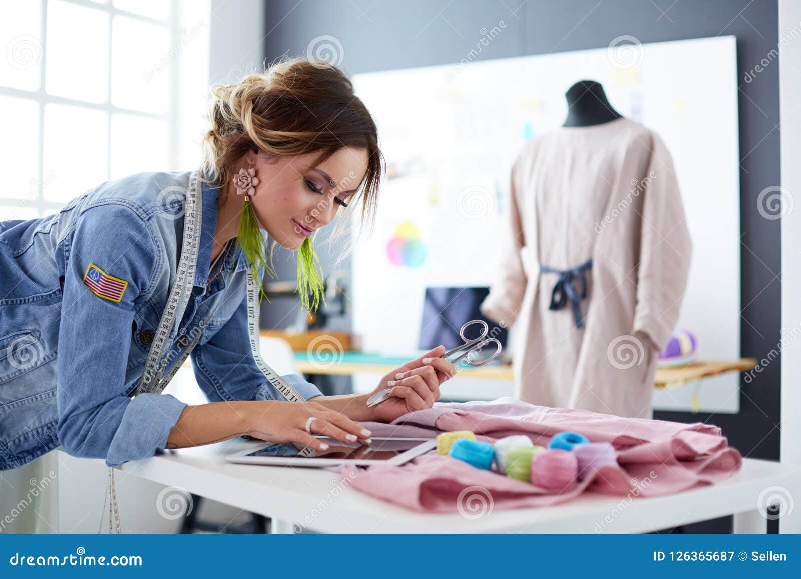 Fashion Designer Woman Working with Ipad on Her Designs in the Studio ...