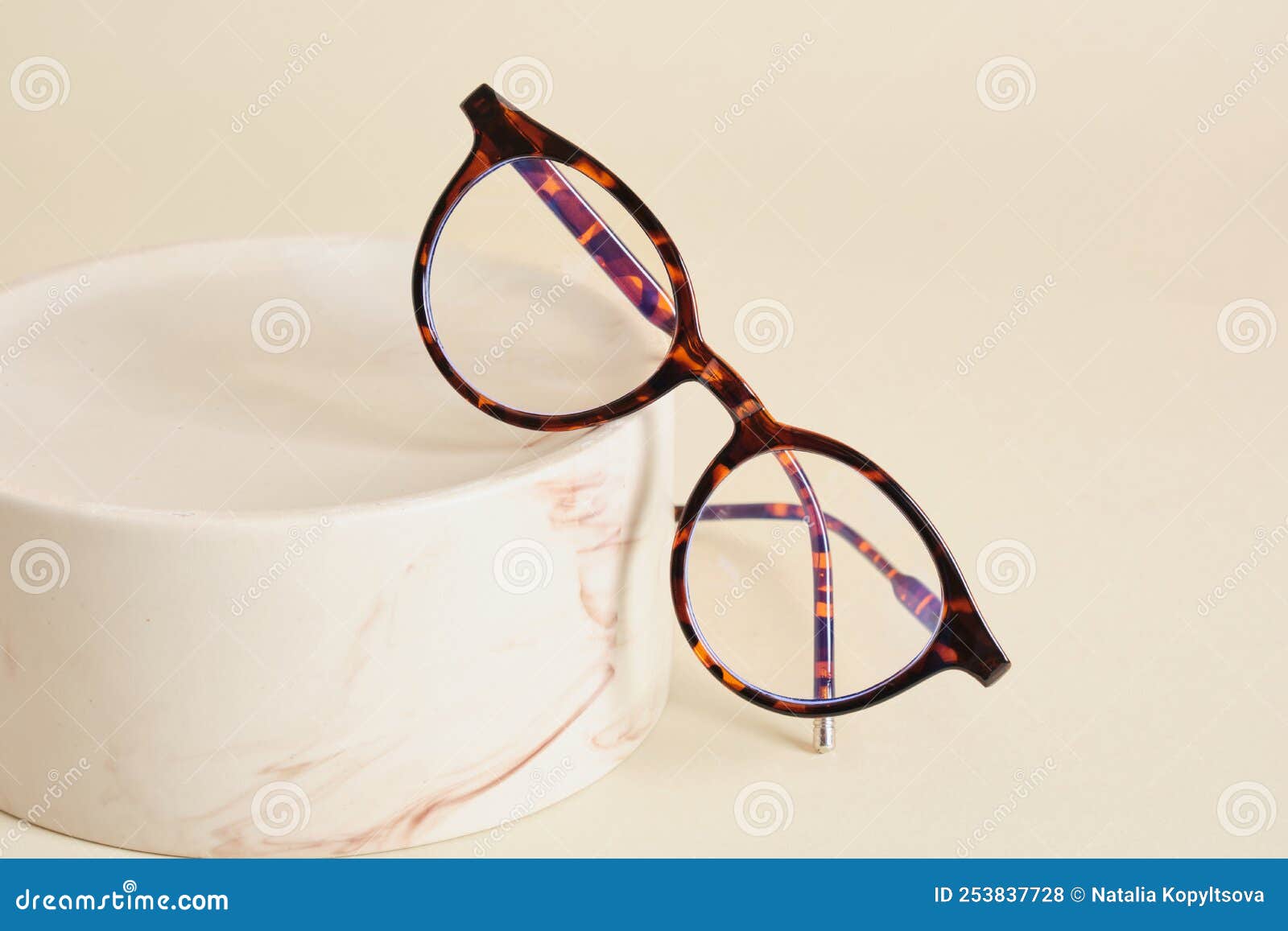 fashion eyeglass frames, glasses on ceramic podium, creative presentation of eyeglasses