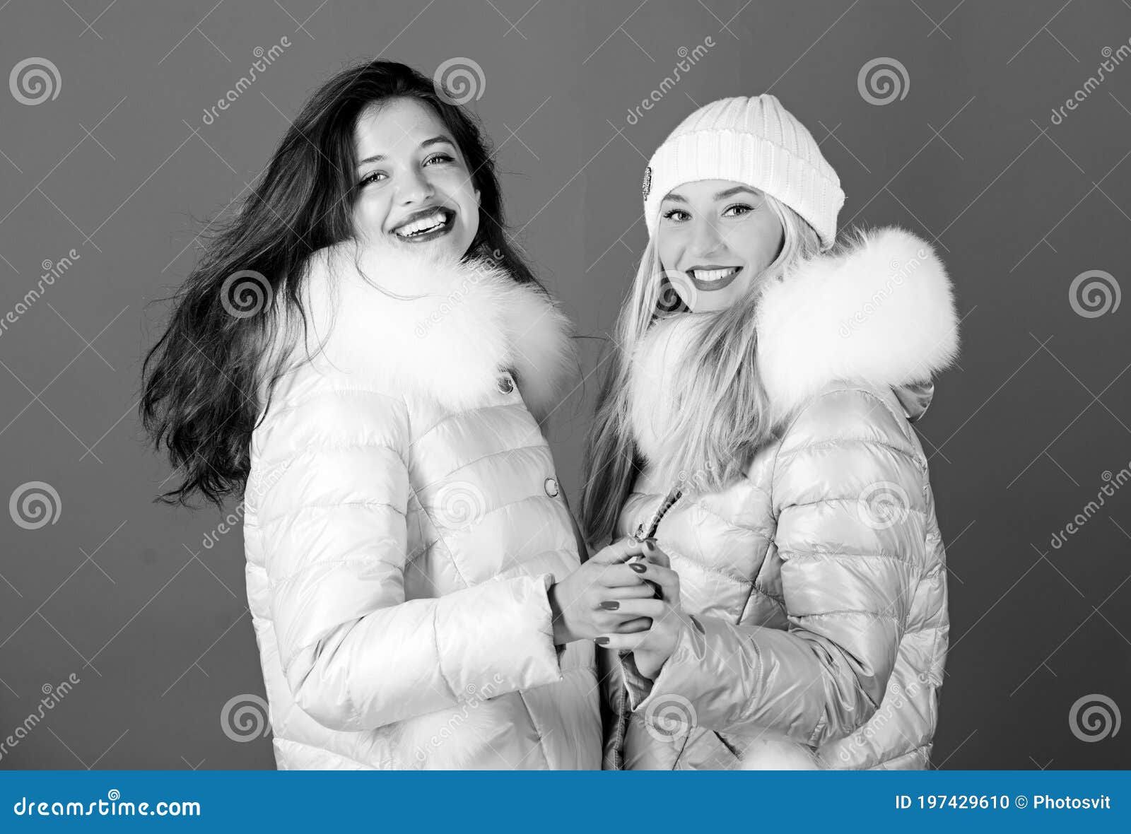 Fashion Friends. Winter Clothes. Women Wear Down Jacket with Furry