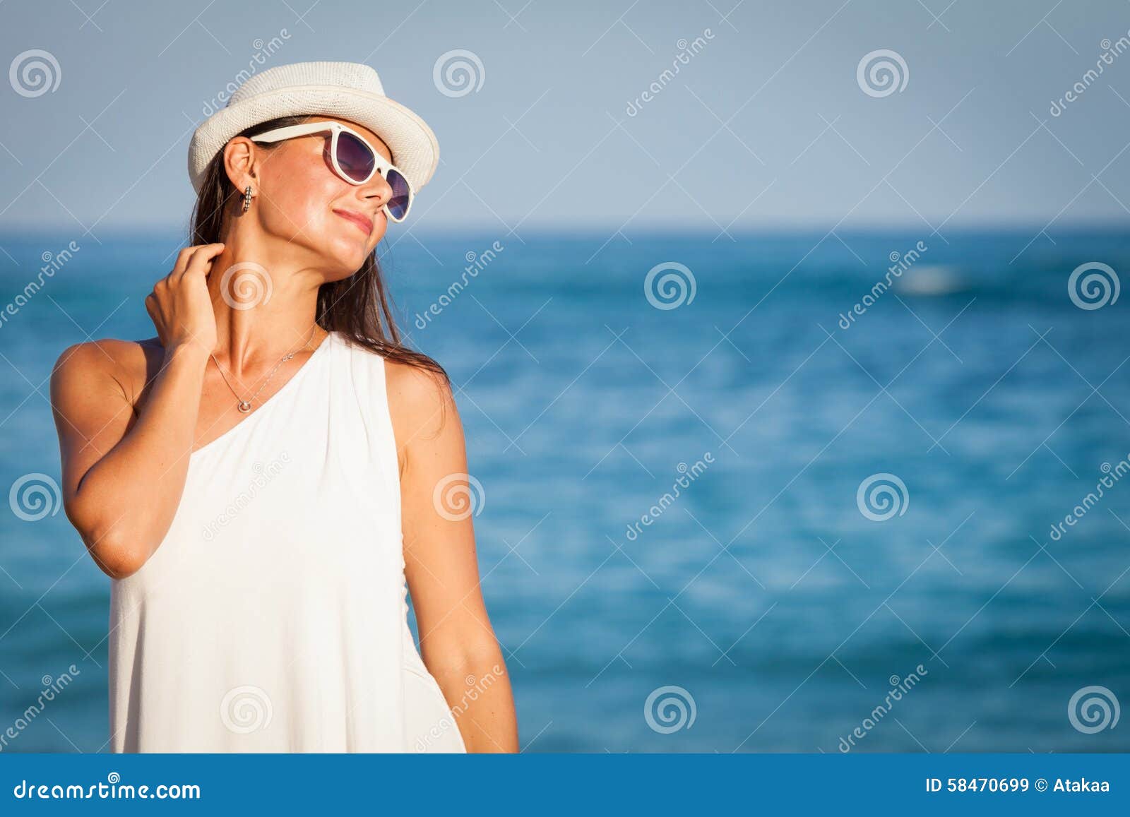 Fashion Lifestyle, Beautiful girl on the beach at the day time. Fashion Lifestyle, Beautiful girl in the sunglasses and white hat on the beach at the day time. Travel and Vacation.