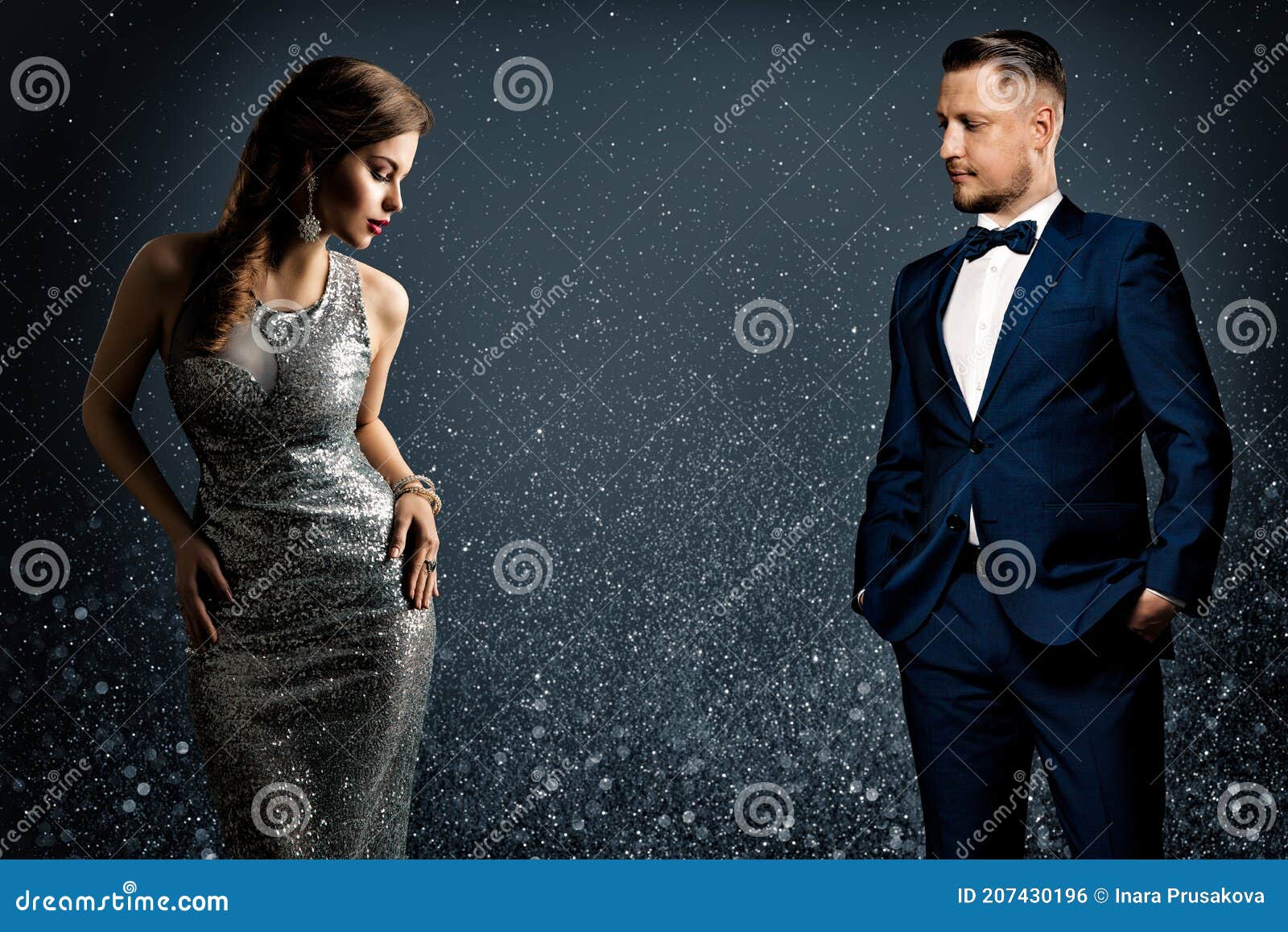 fashion luxury couple. glamour woman and handsome man. elegant pair in evening dress and suit. sparkling background