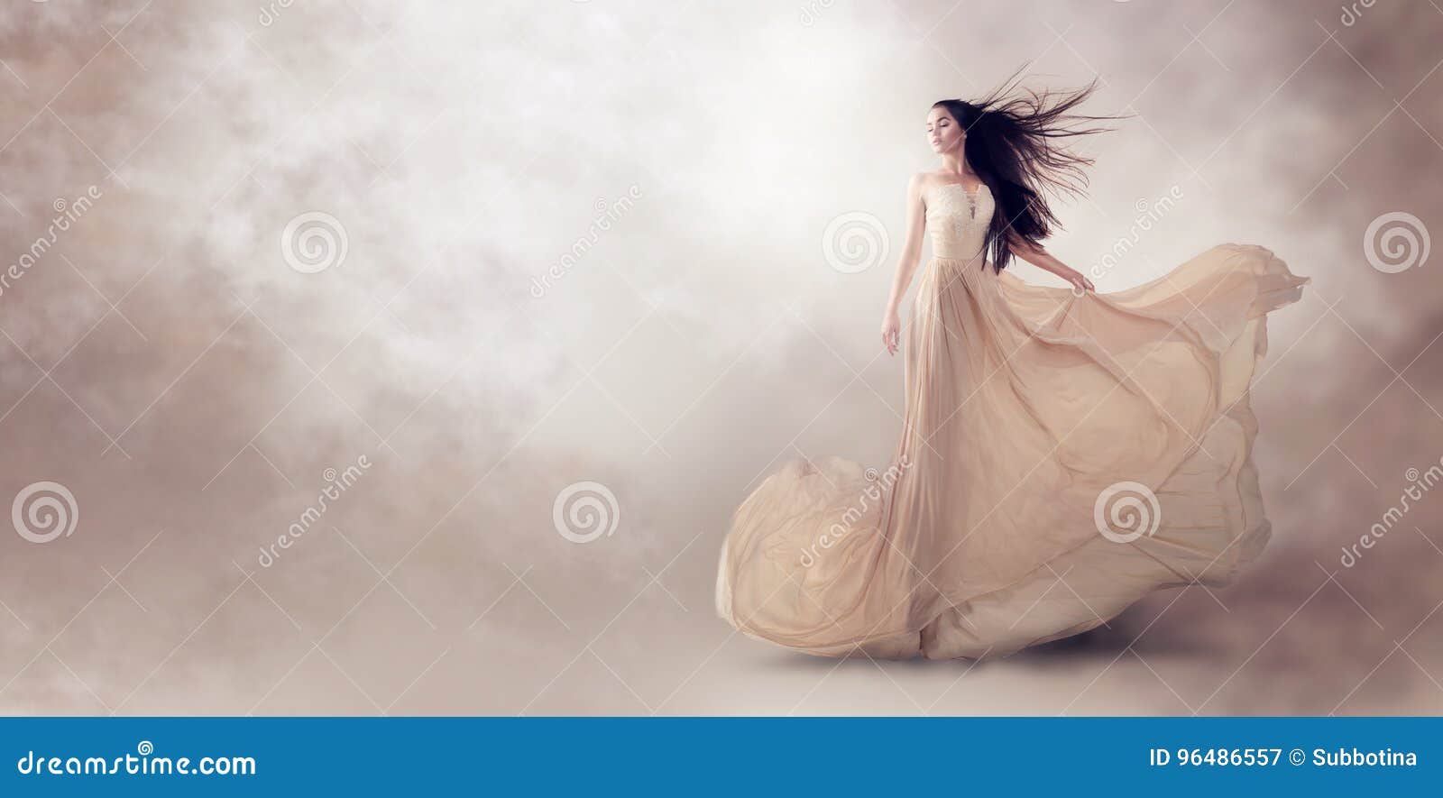 fashion model in beautiful beige flowing chiffon dress