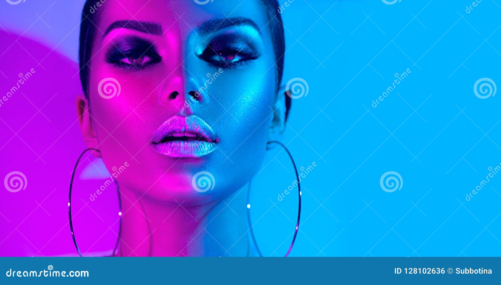 fashion model brunette woman in colorful bright neon lights posing in studio. beautiful girl, trendy glowing makeup