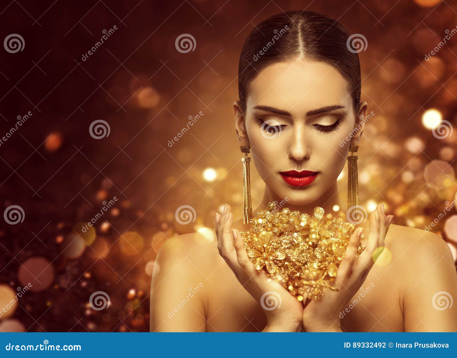 fashion model holding gold jewelry in hands, woman golden beauty