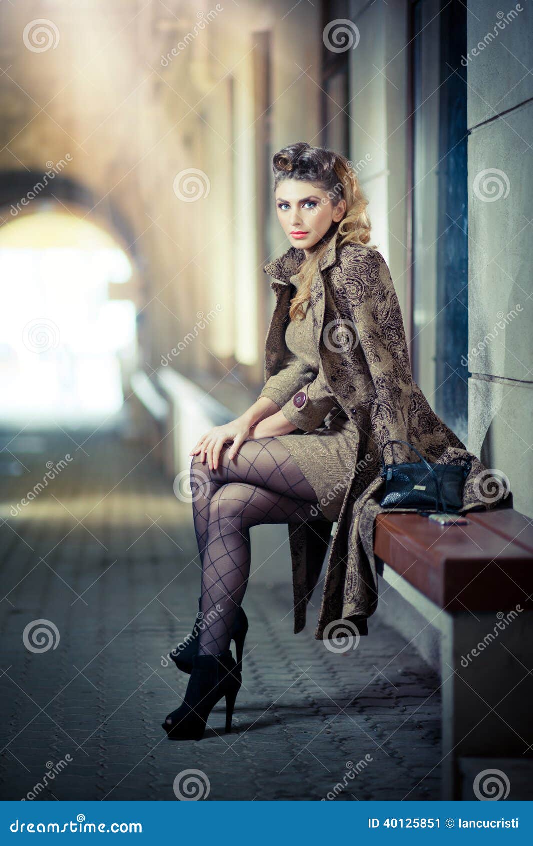 Sexy Female Legs. Fashion Long Legs Blonde Girl Sitting on Bench Stock  Photo