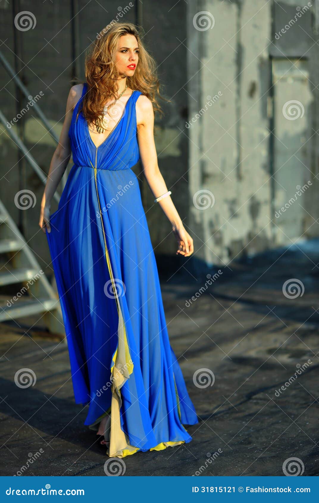 Fashion Model Posing Sexy Wearing Long Blue Evening Dress