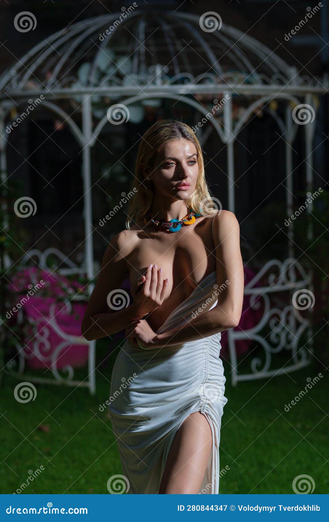 Fashion Model in White Dress Covering Breast with Hand. Boobs