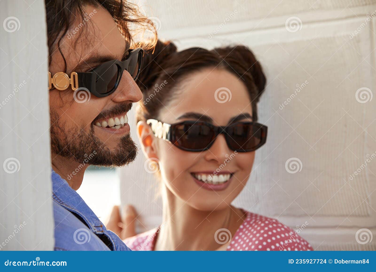 Fashion Models Couple Wearing Sunglasses Woman And Handsome Young Man Portrait Over Light