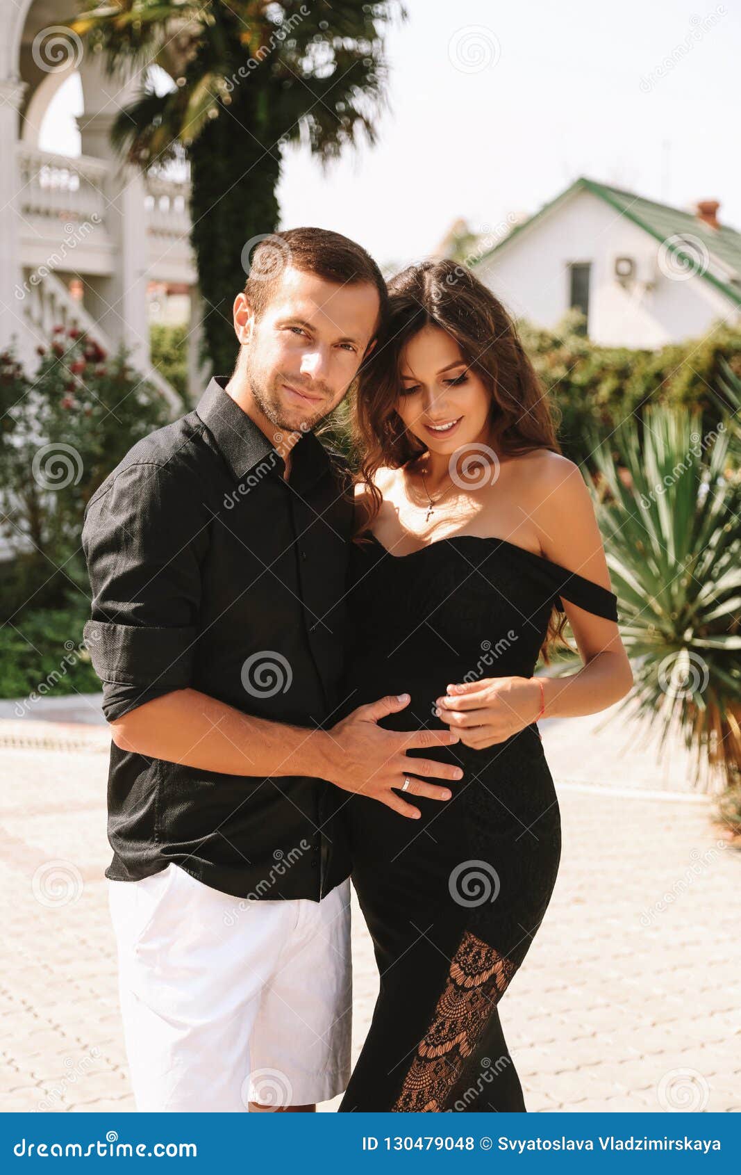 Gorgeous Pregnant Woman With Dark Hair In Elegant Dress