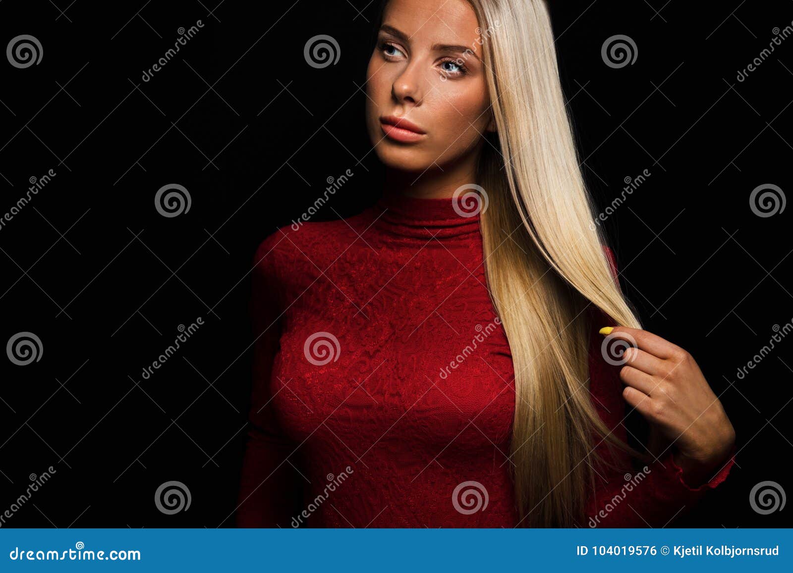 Dark Portrait Of A Beautiful Blonde Woman In Red Dress With Black