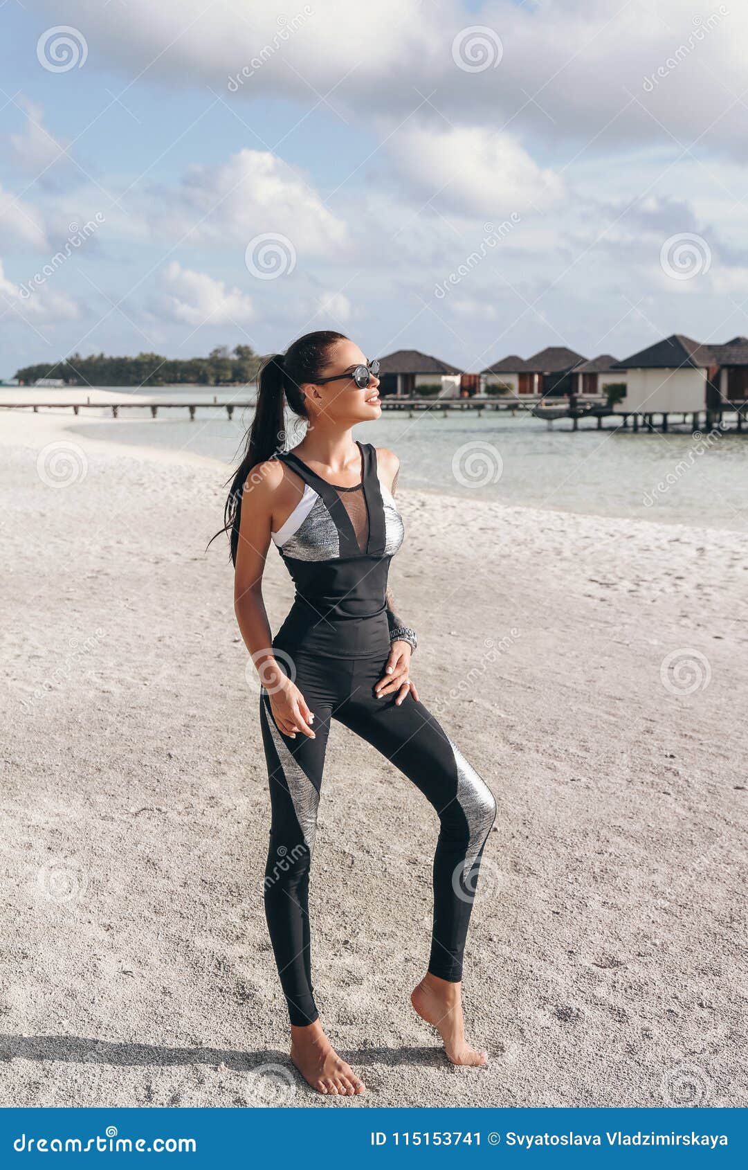beautiful woman with dark hair in sport suit relaxing on maldive