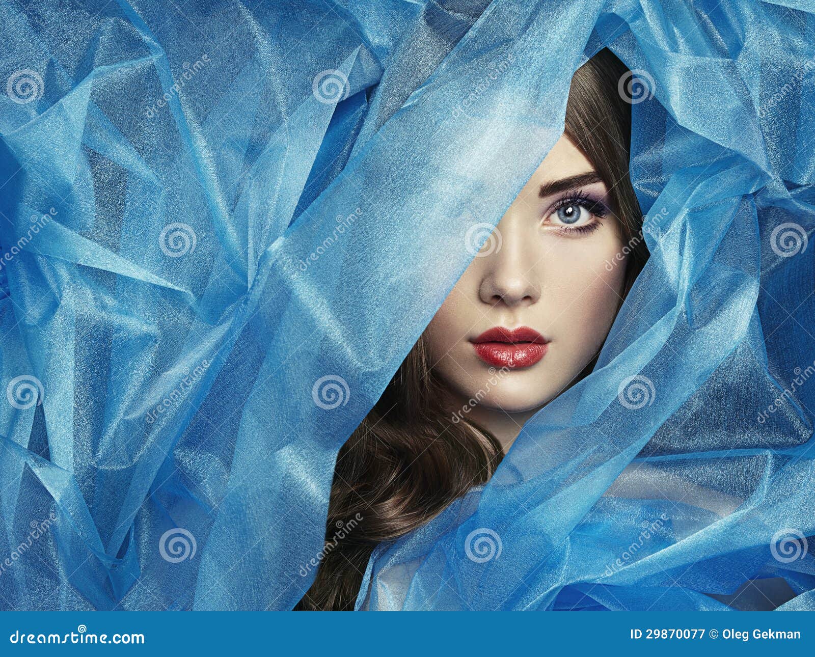 fashion photo of beautiful women under blue veil