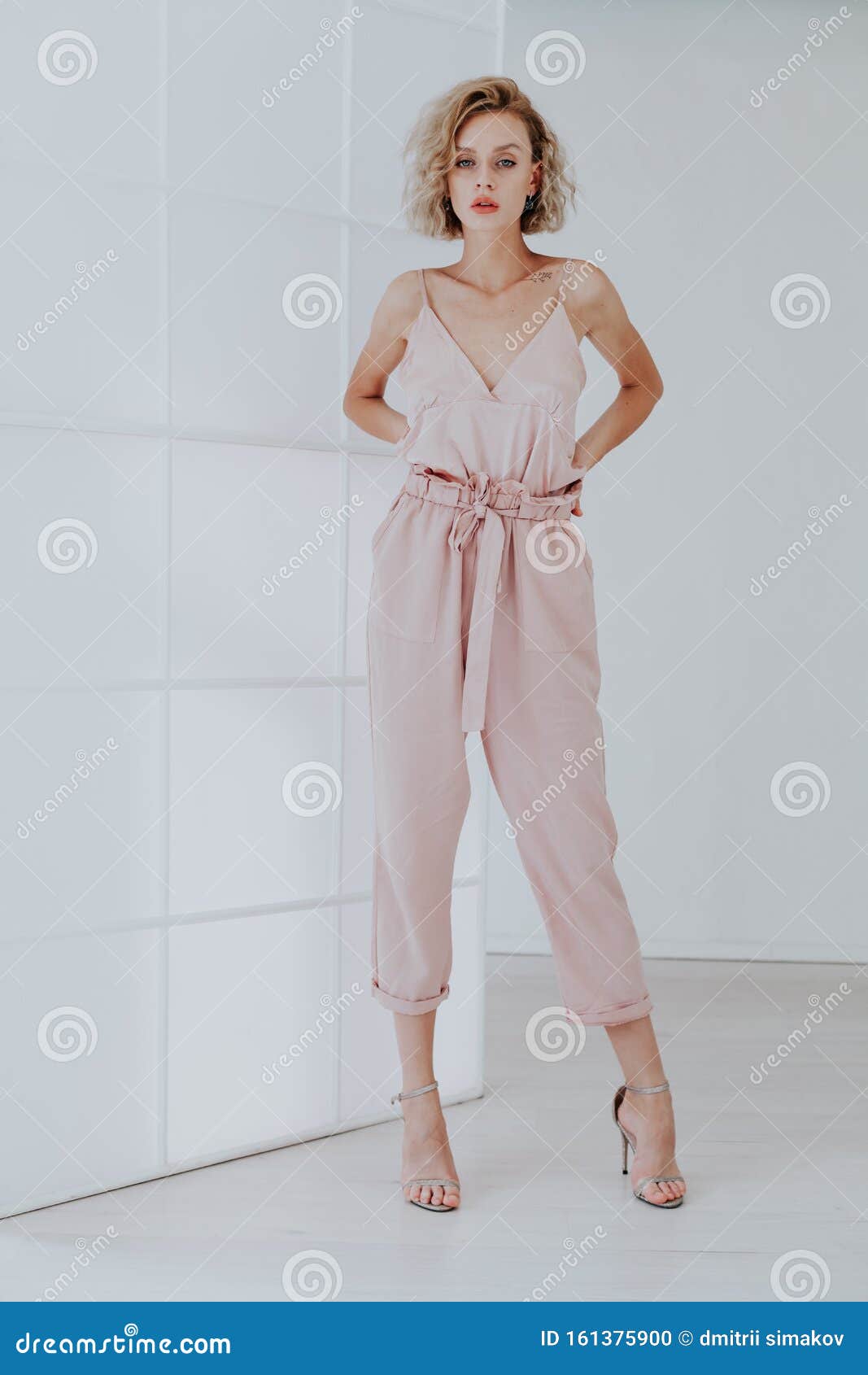 Fashion Portrait of a Beautiful Woman in Pink Clothes on a White ...
