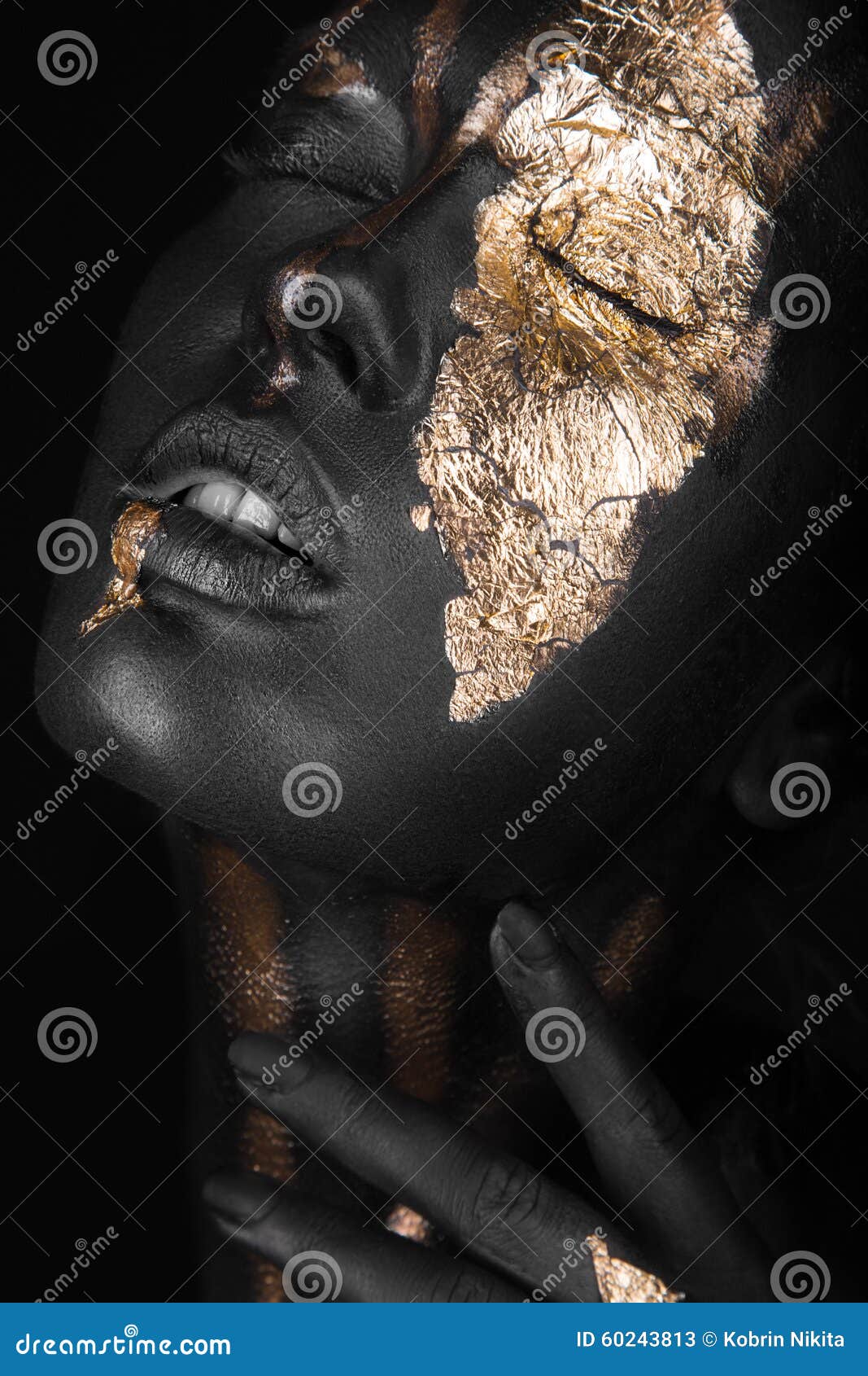 fashion portrait of a dark-skinned girl with gold make-up. beauty face.