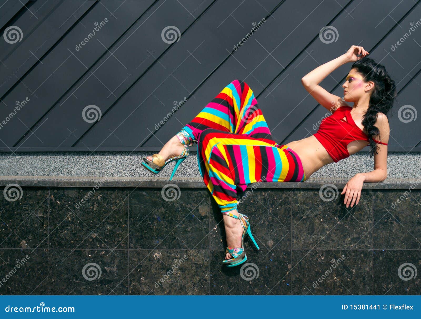 fashion portrait of young woman in color outfit