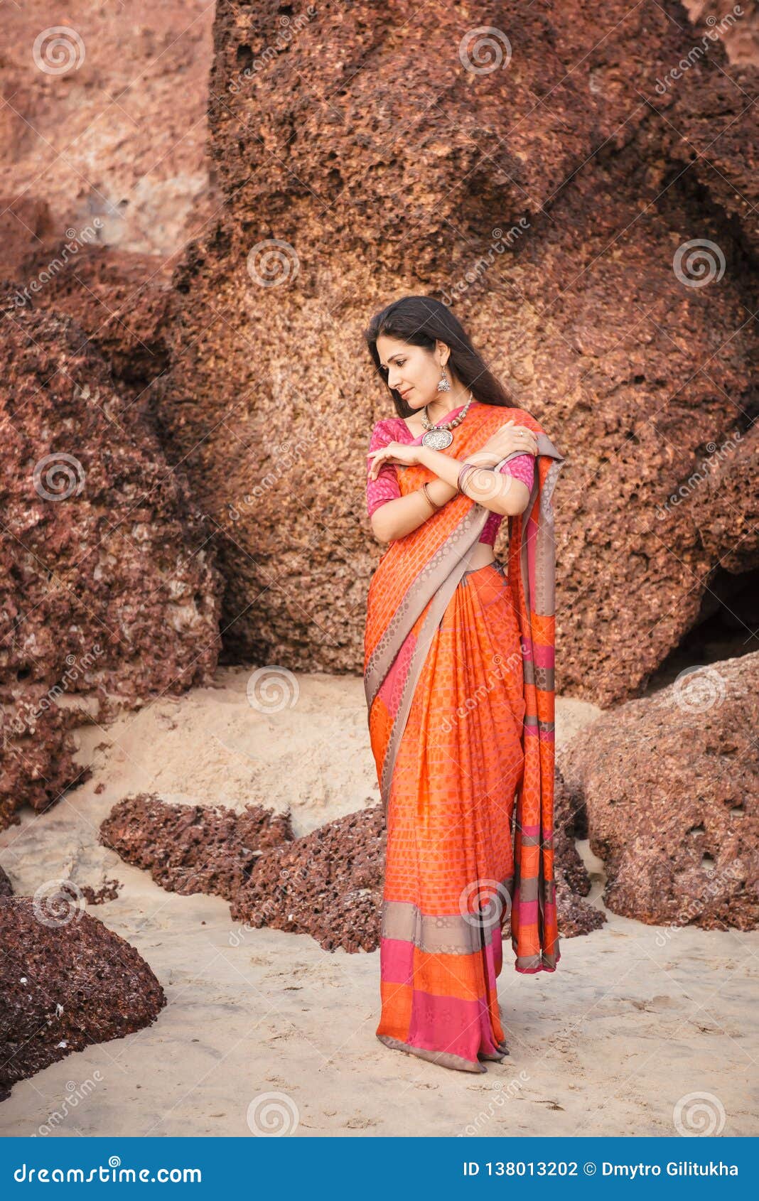 beautiful indian woman in saree posing by water. AI-Generated 32589917  Stock Photo at Vecteezy