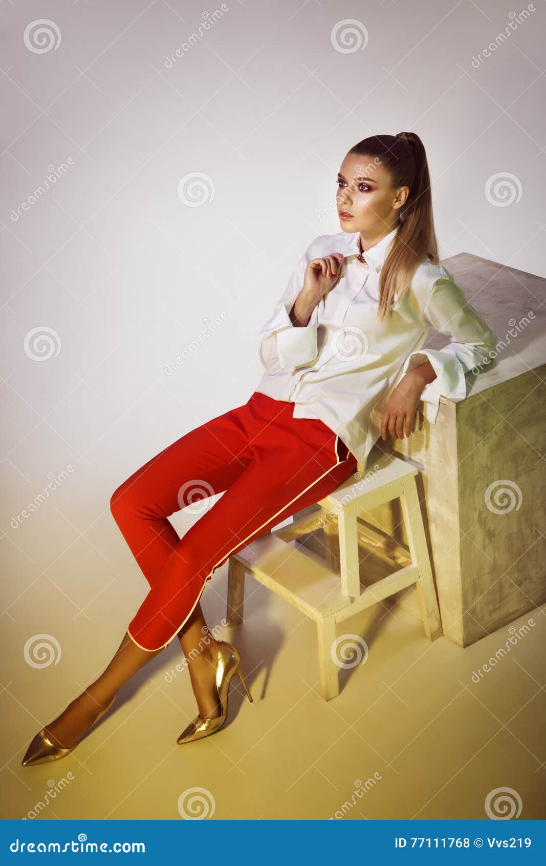 Fashion Studio Shoot of Posing Woman on White Cube Stock Photo Image