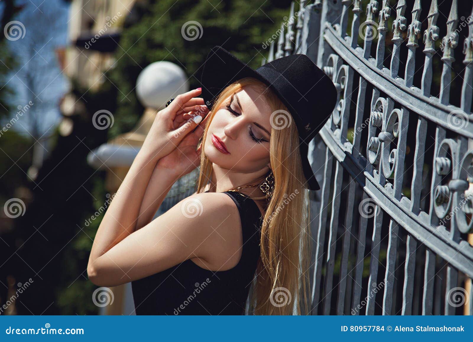 Fashion Woman Posing with Hat Near Metal Fence Stock Photo - Image of ...