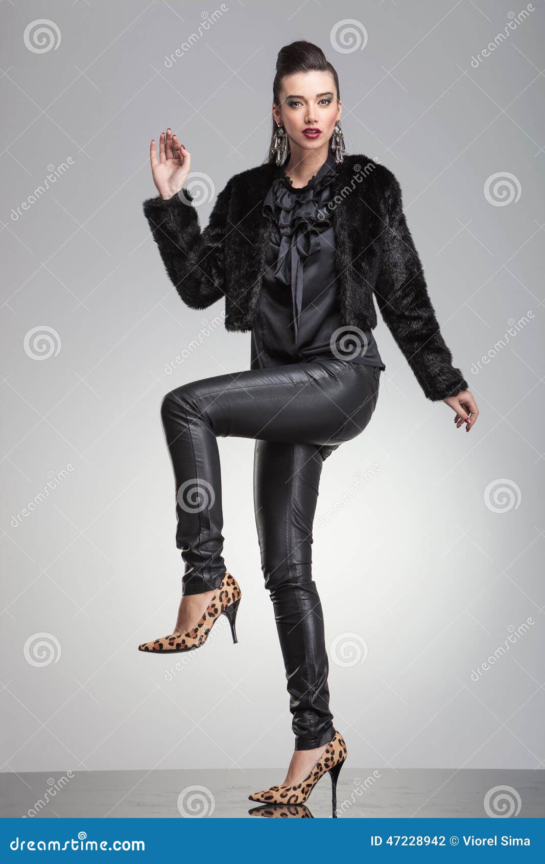 Fashion Woman Posing with One Leg and One Hand Up. Stock Photo - Image ...