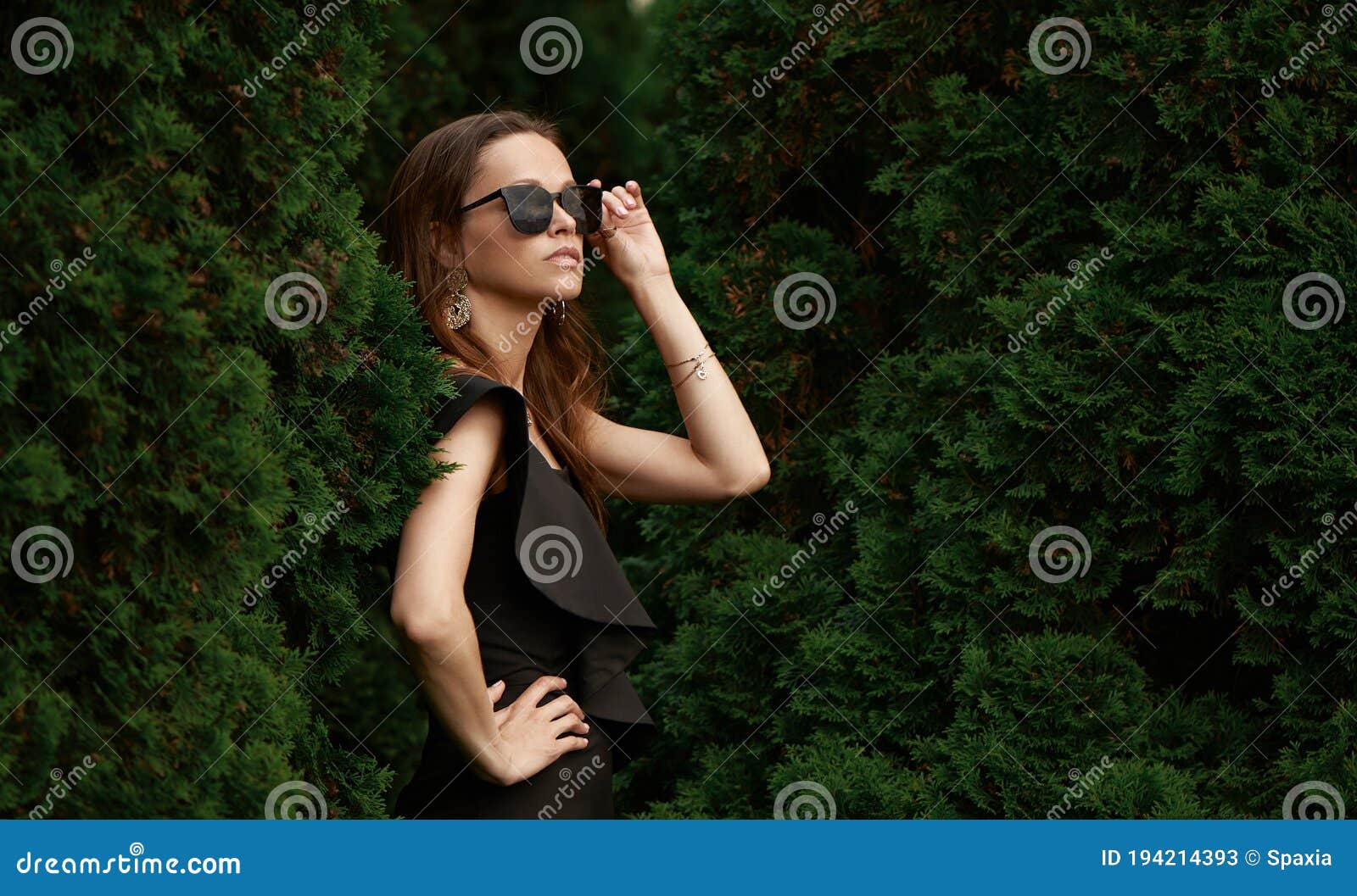 Fashionable Beautiful Woman Is Wearing Sunglasses In The Park Stock