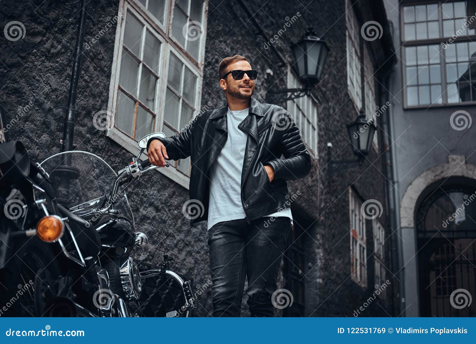 Fashionable Biker in Sunglasses Dressed in a Black Leather Jacket and ...