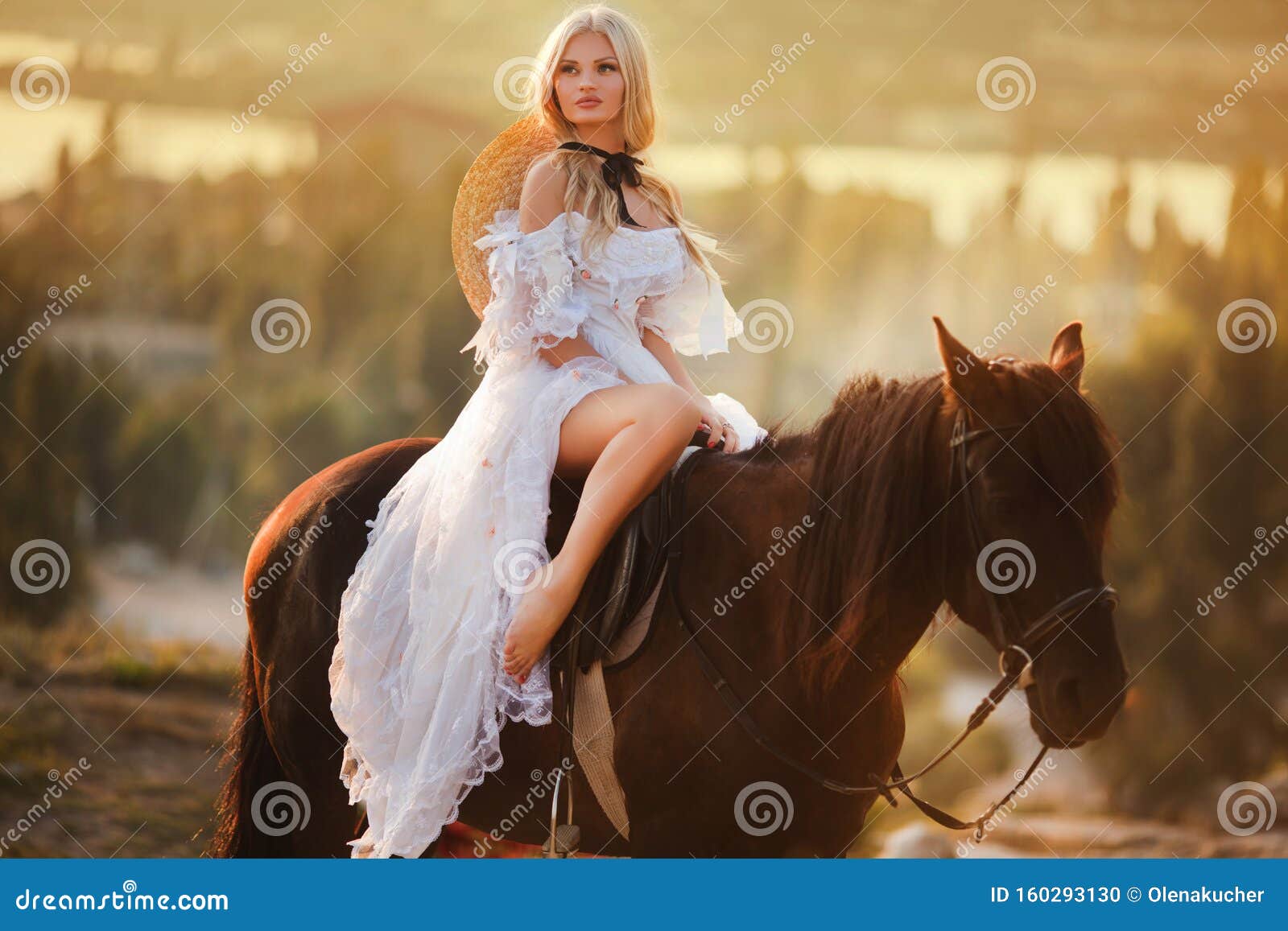 Fashionable Blonde Woman Riding A Horse In Sunny Day Stock Photo