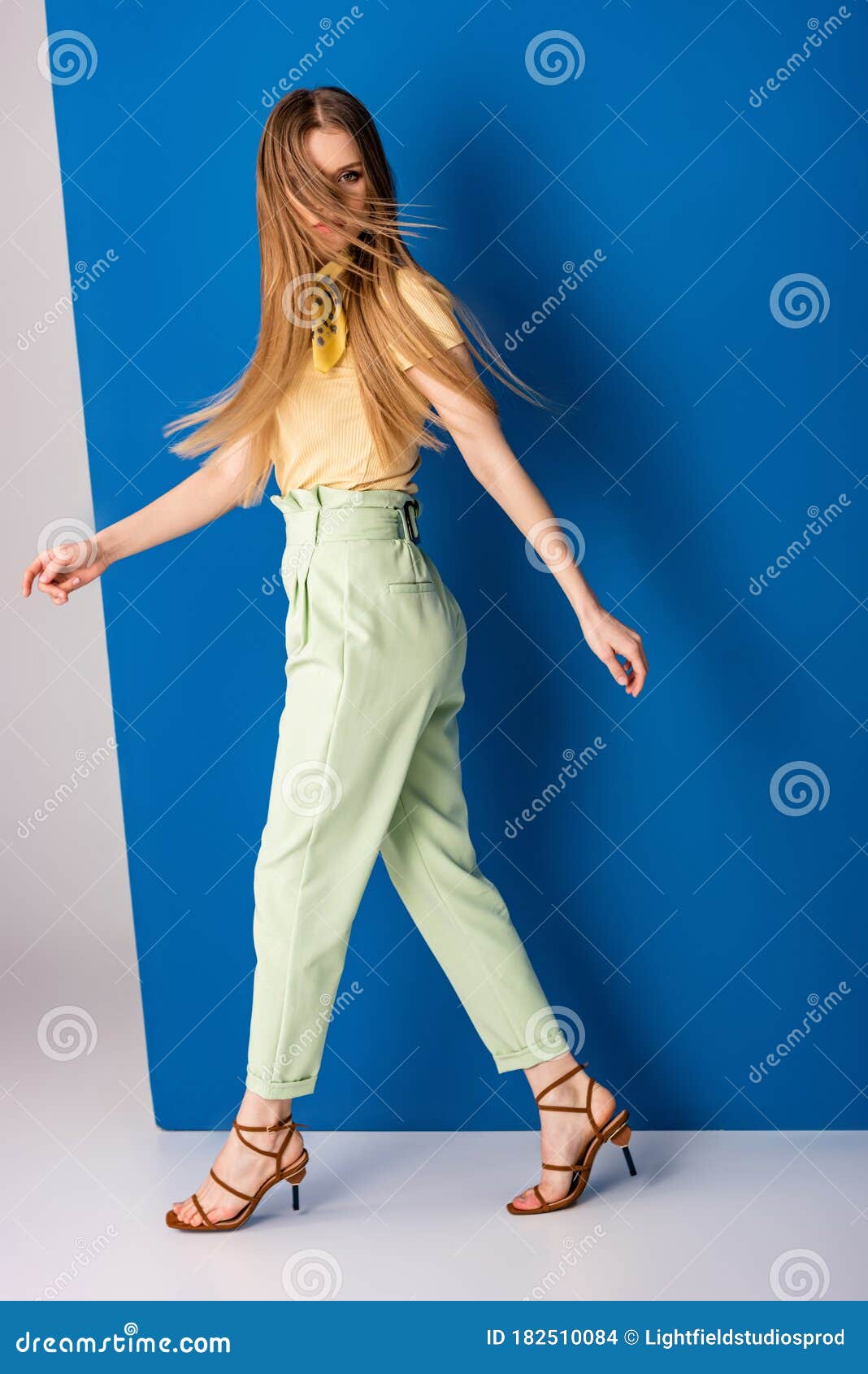 Fashionable Girl Posing in Green Summer Trousers and Heeled Sandals on ...