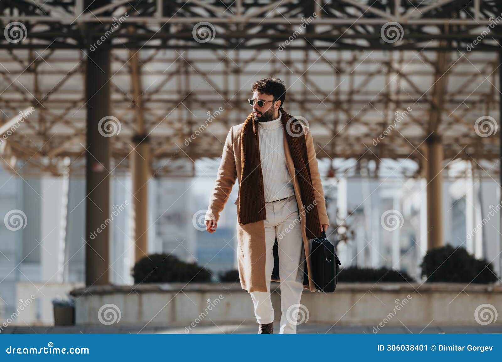 stylish young man walking with confidence in urban setting.