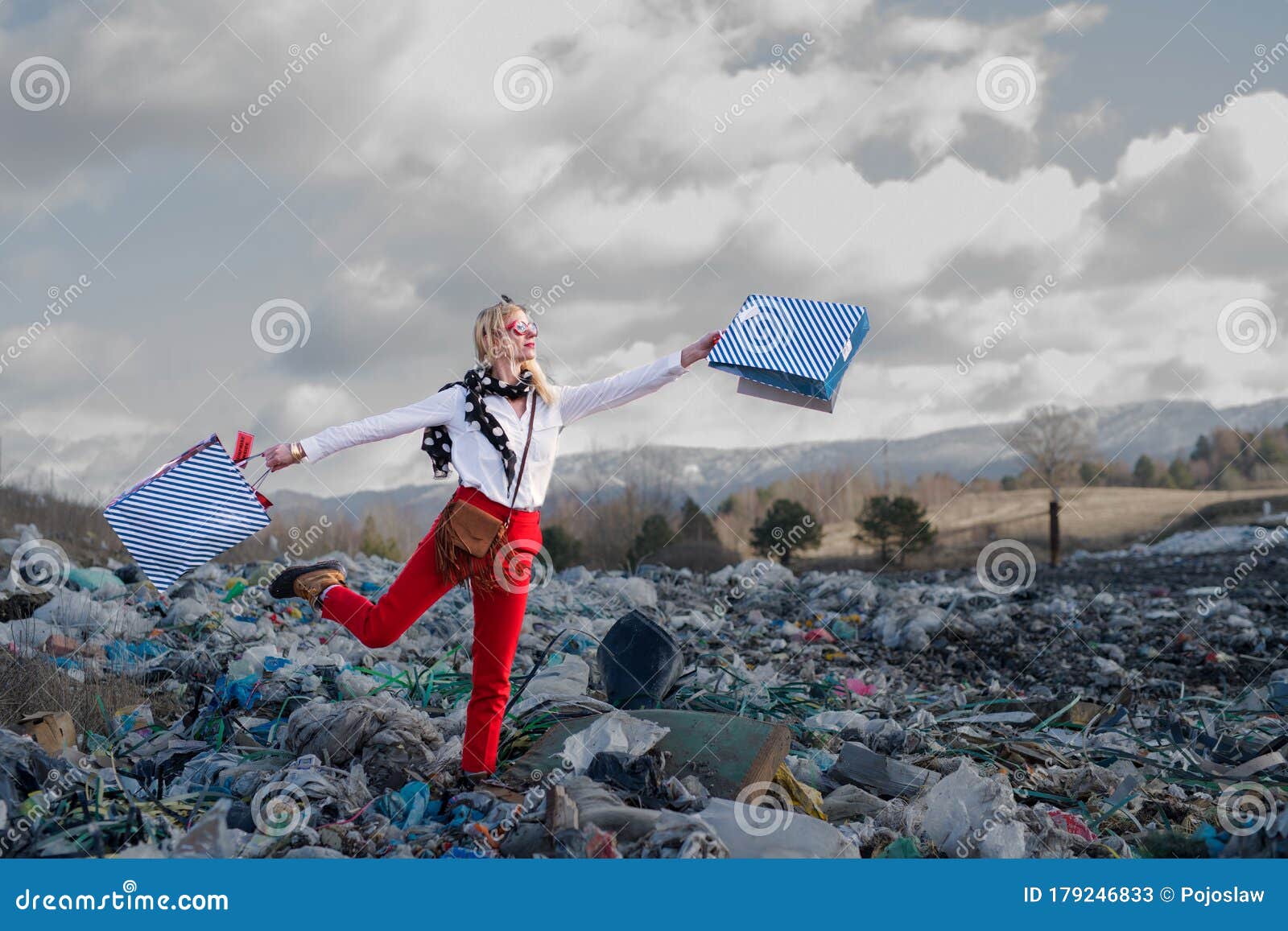 modern woman on landfill, consumerism versus pollution concept.