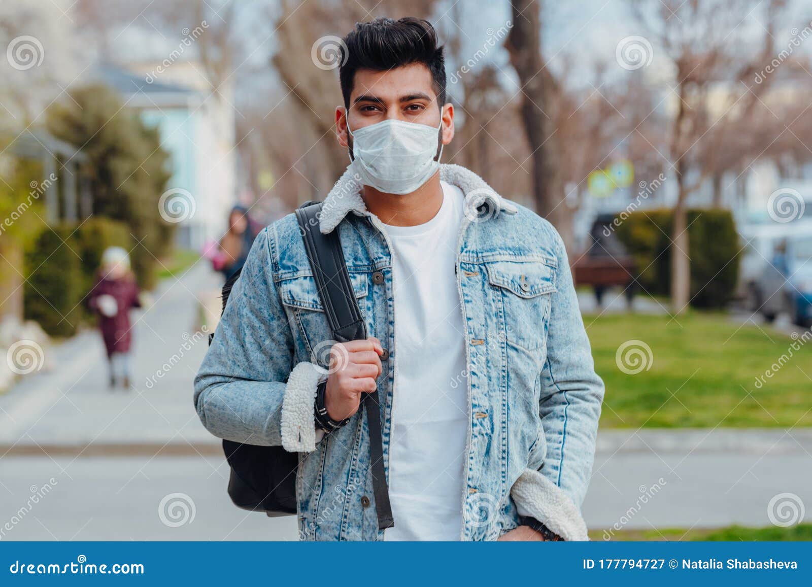 A Fashionably Dressed Young Indian Man in a Medical Mask Walks on the ...