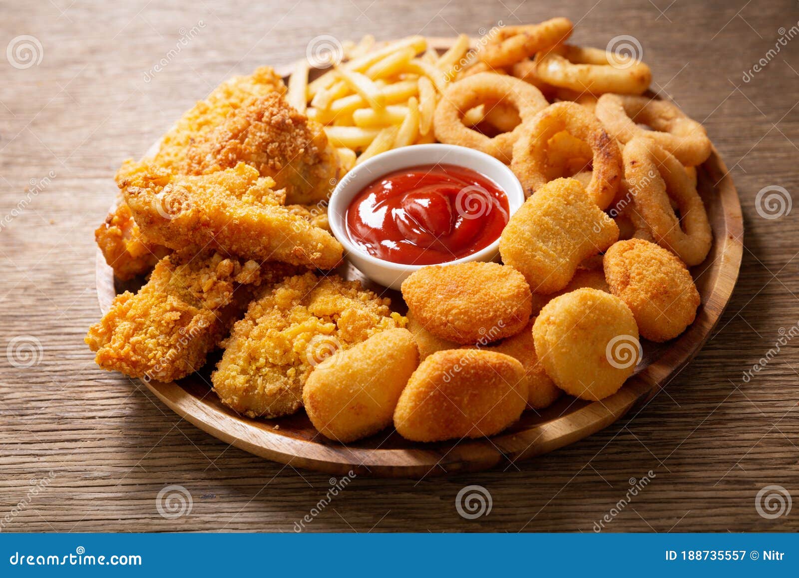 fast food meals : onion rings, french fries, chicken nuggets and fried chicken