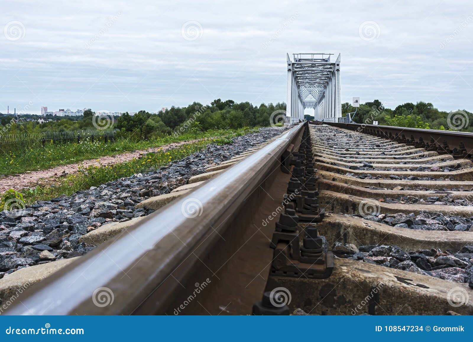 Railroad Tracks Go into the Distance To the Railway Bridge Stock Photo