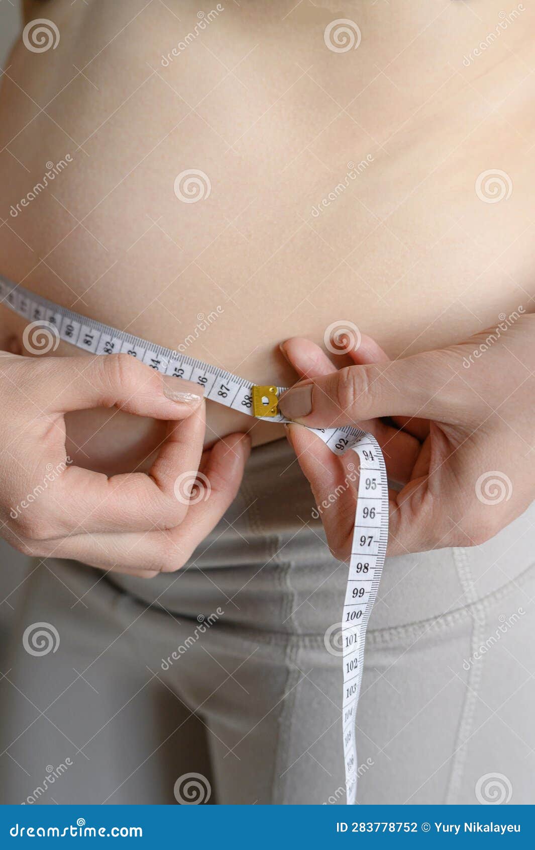 A Fat Woman Measures Her Waist with a Measuring Tape, Close-up