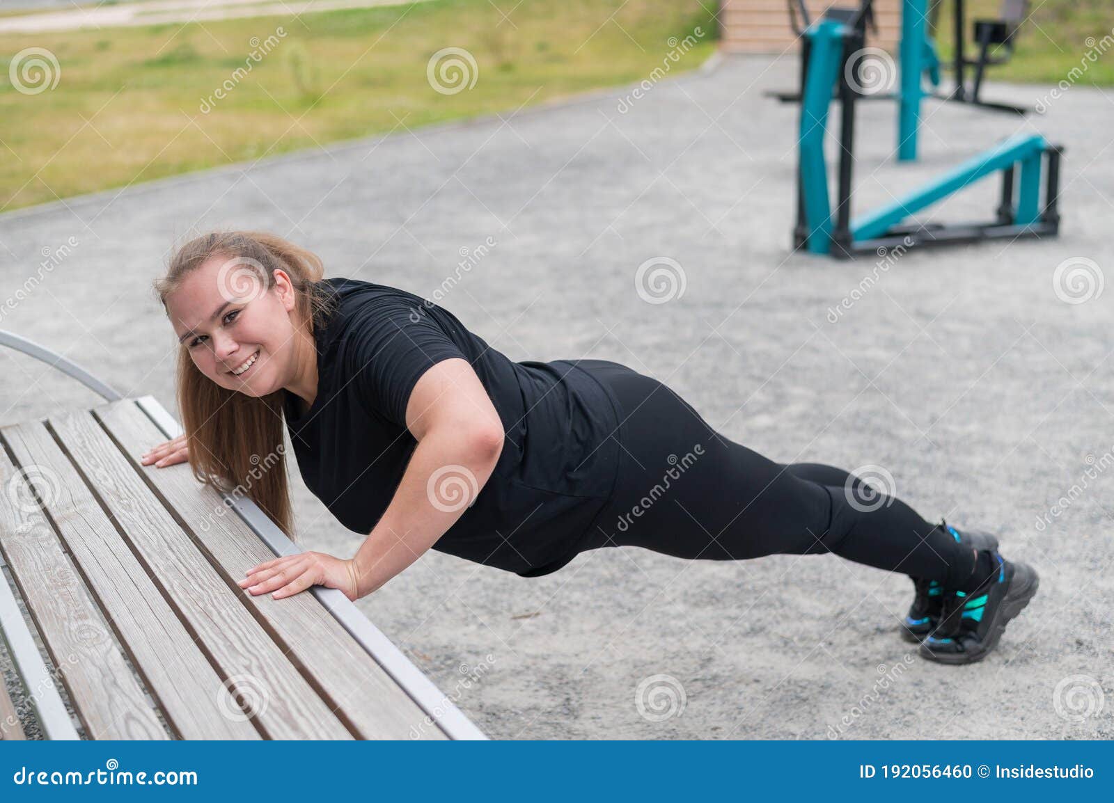 Fat Chubby Female Warms Up Muscles before Yoga or Sport Exercises