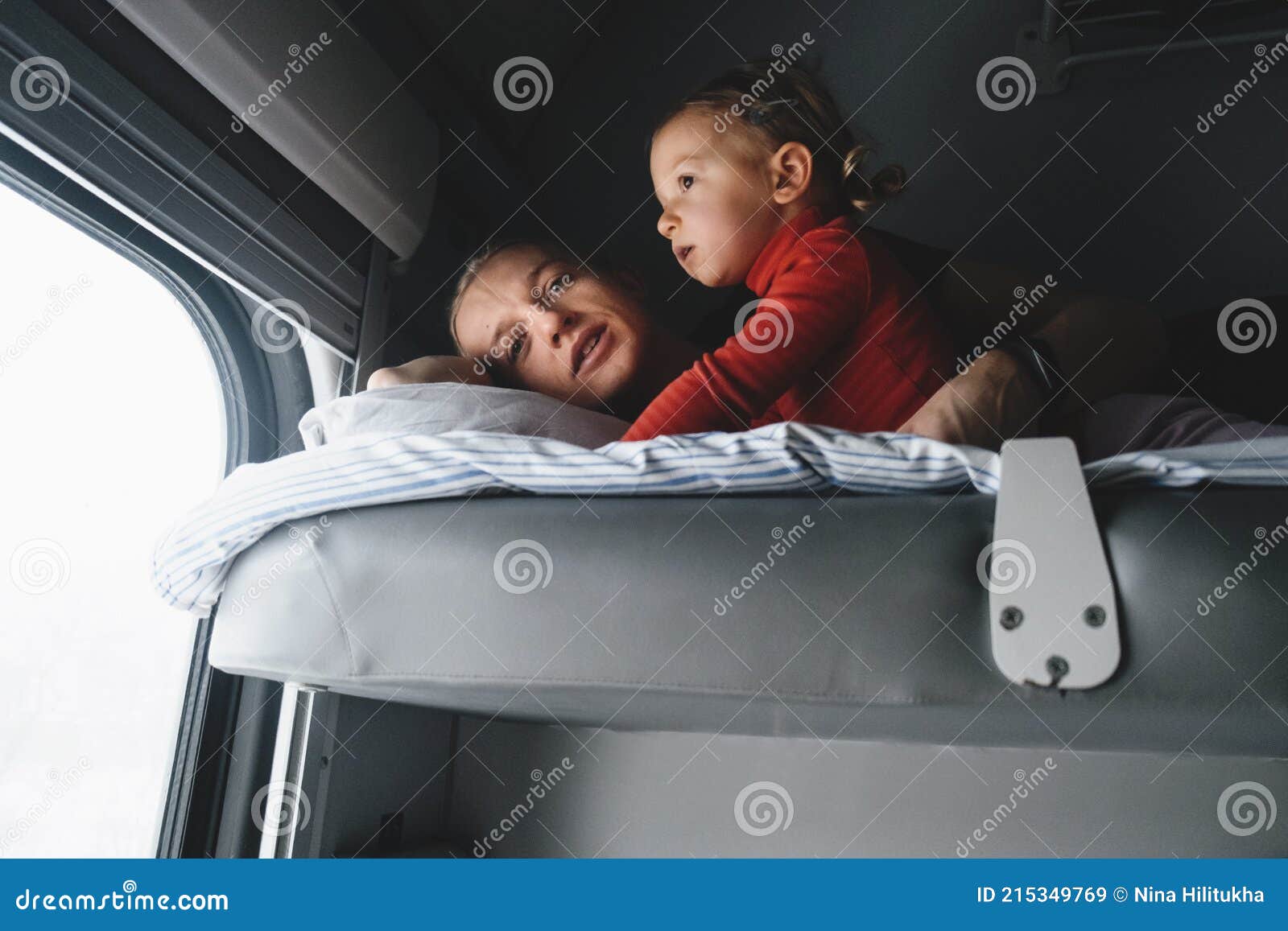father with child travalling in train, having fun enjoying scene through window