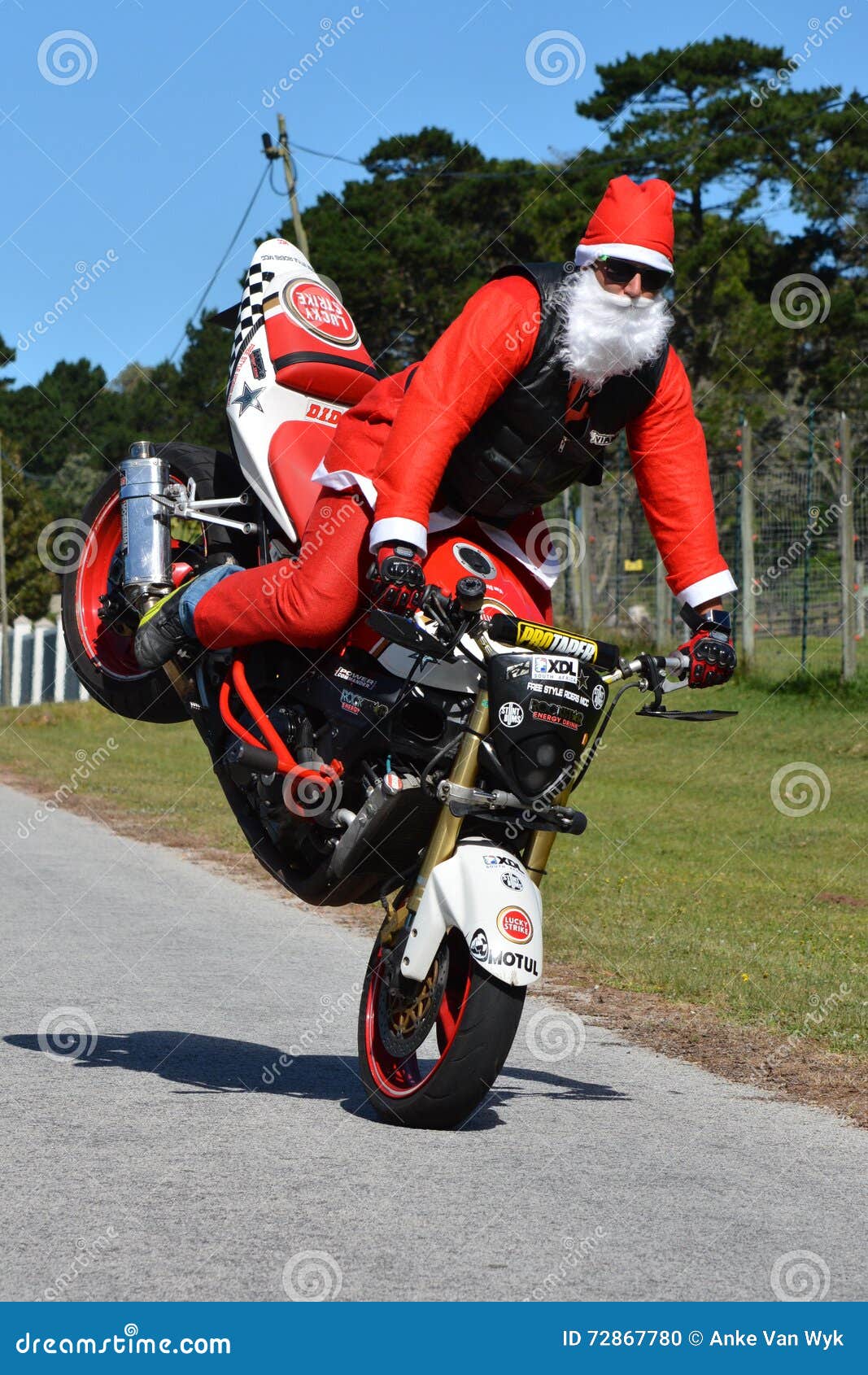 father-christmas-doing-front-wheel-wheelie-long-white-beard-red-motorbike-having-fun-72867780.jpg