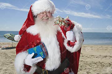 Father Christmas Stands with His Sack on Beach Stock Image - Image of ...