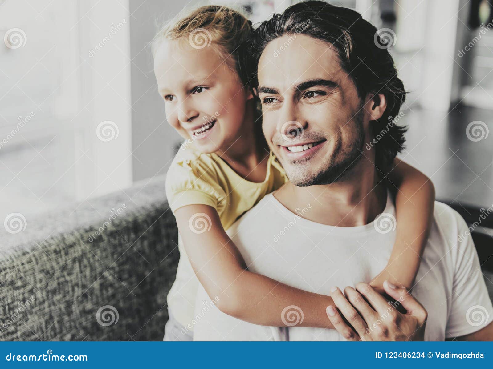 father and daughter hugging and watcing each other