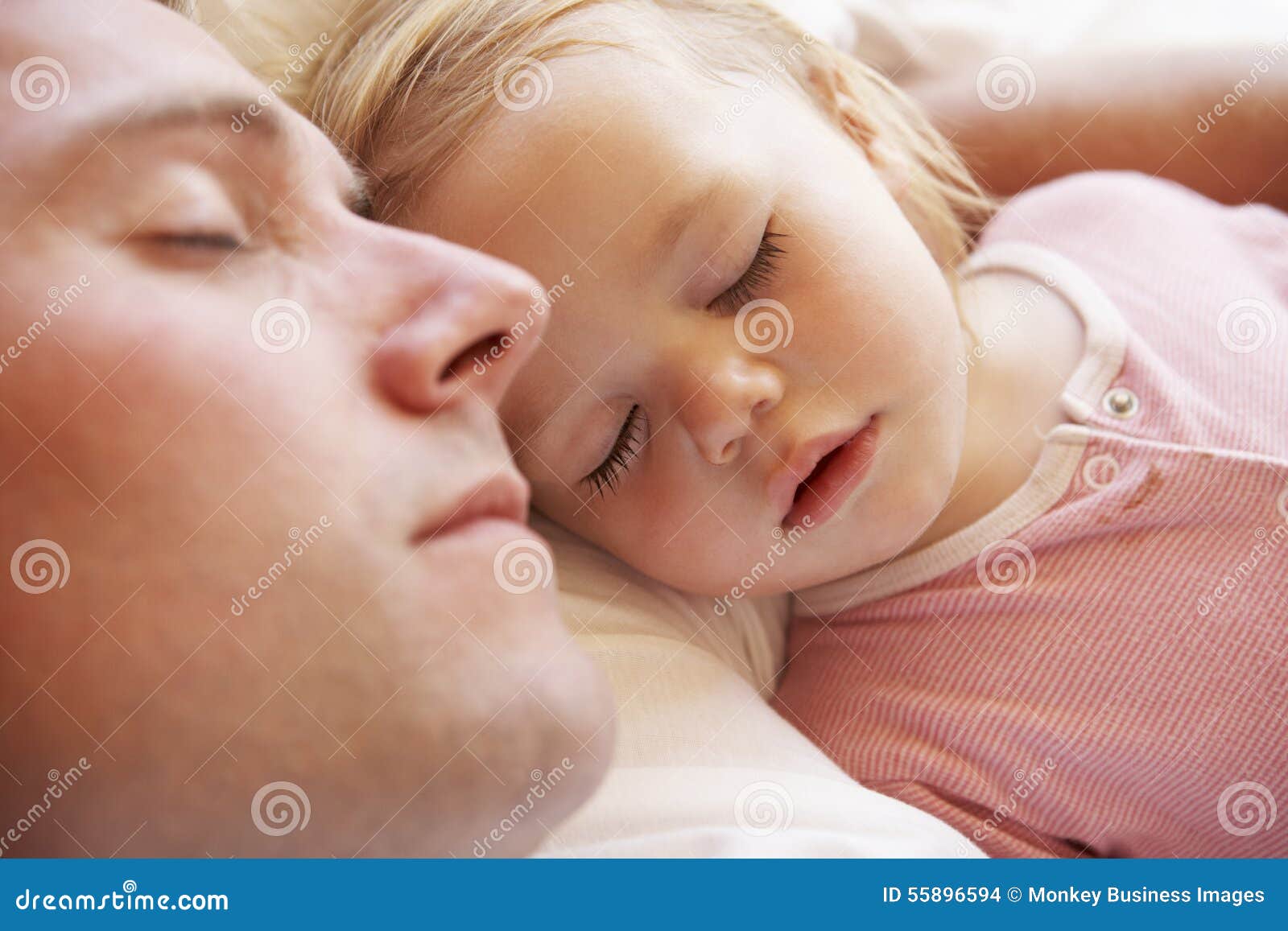 father and daughter sleeping in bed