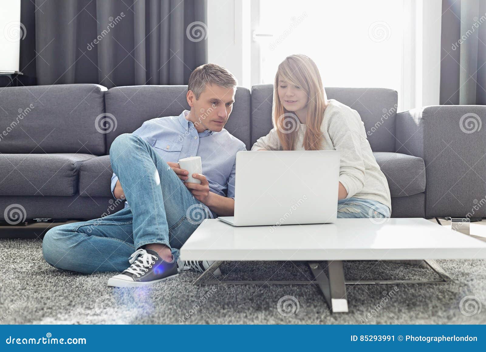Father and Daughter Using Laptop in Living Room Stock Image Image of