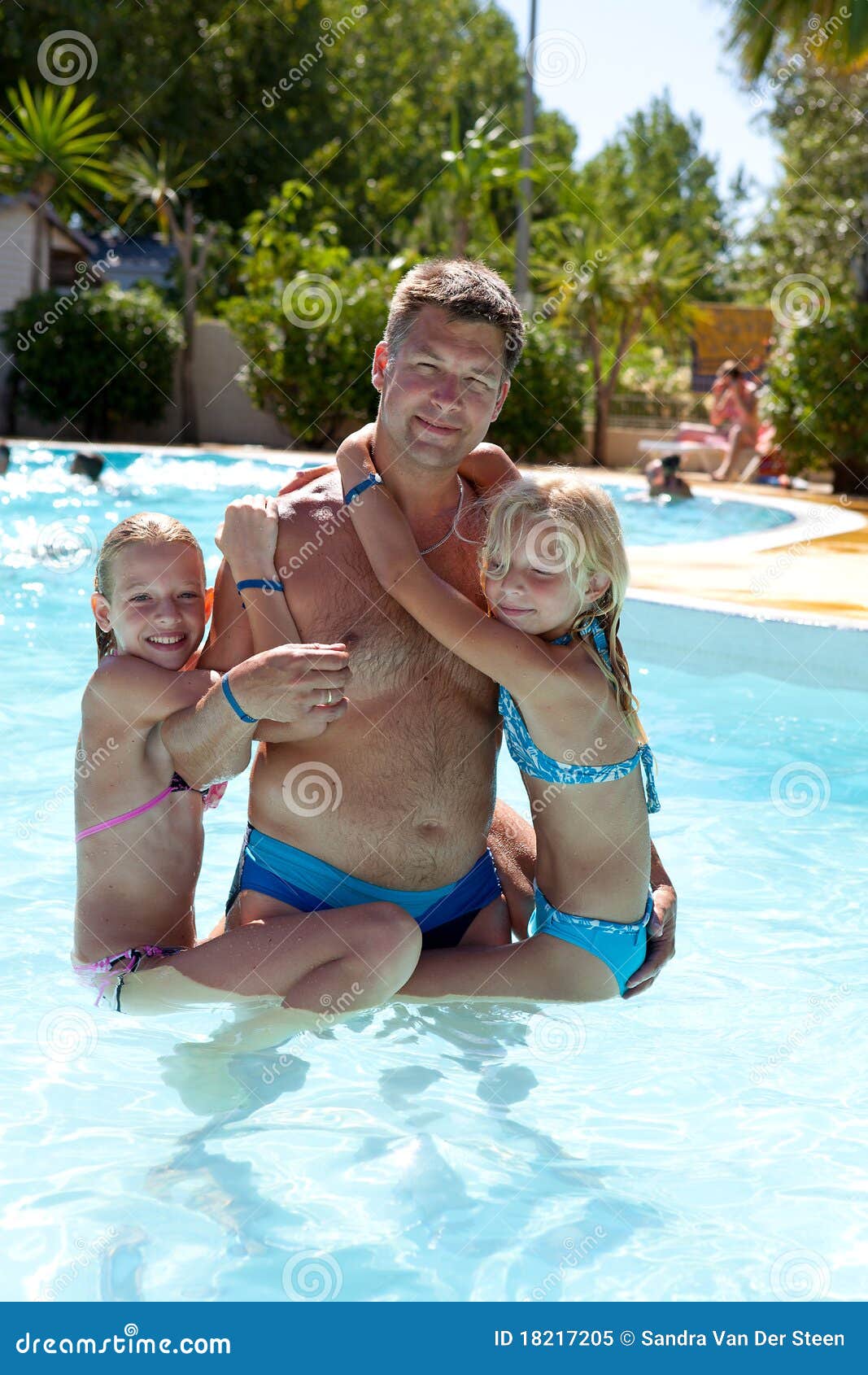 father and daughters in the swim pool