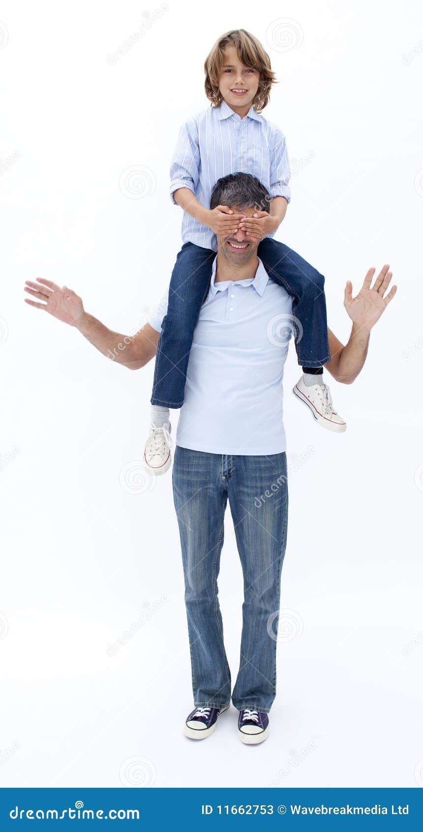 Man giving boy piggyback ride Man giving boy piggy back ride against white  background, model