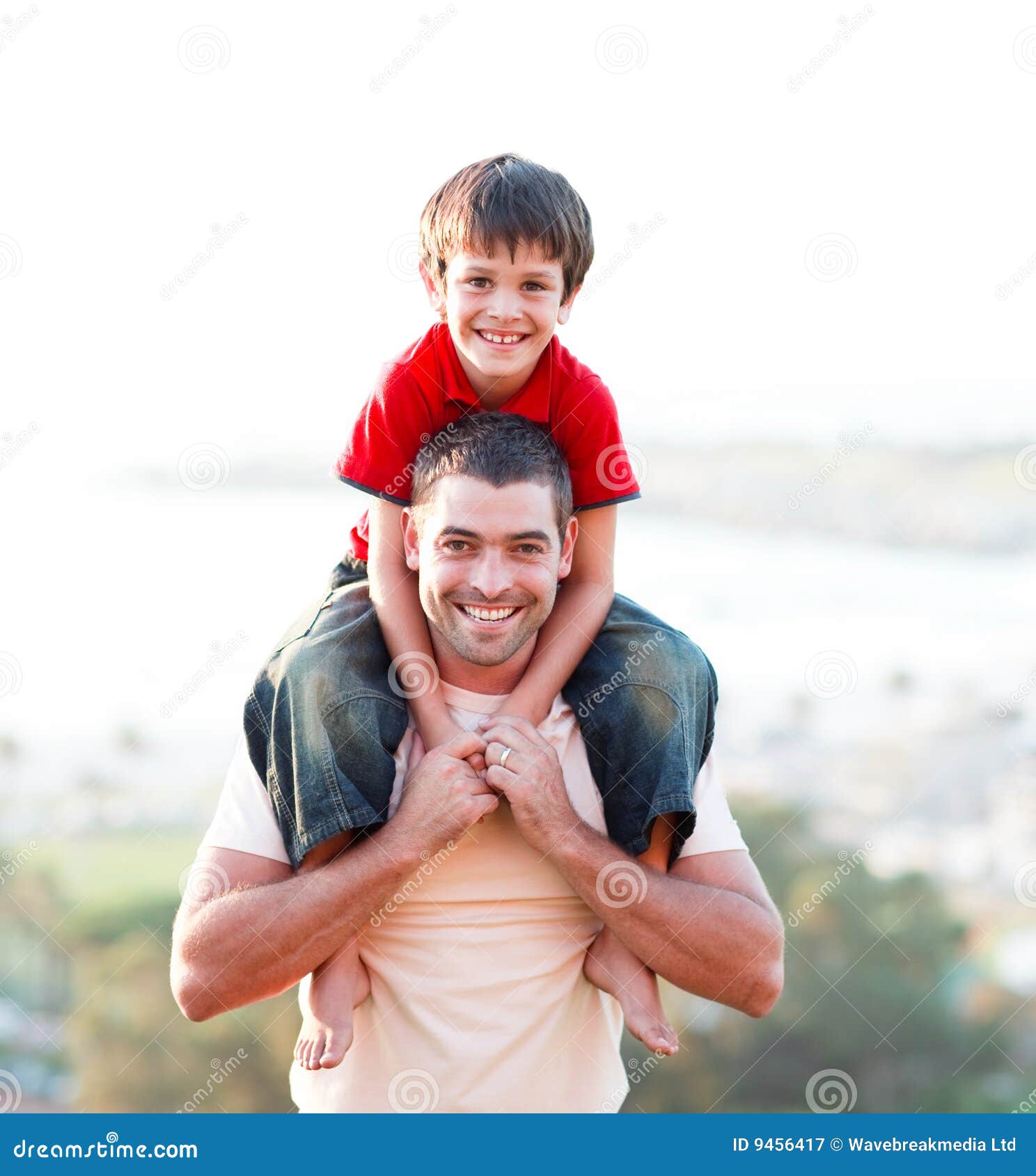 Man giving boy piggyback ride Man giving boy piggy back ride against white  background, model