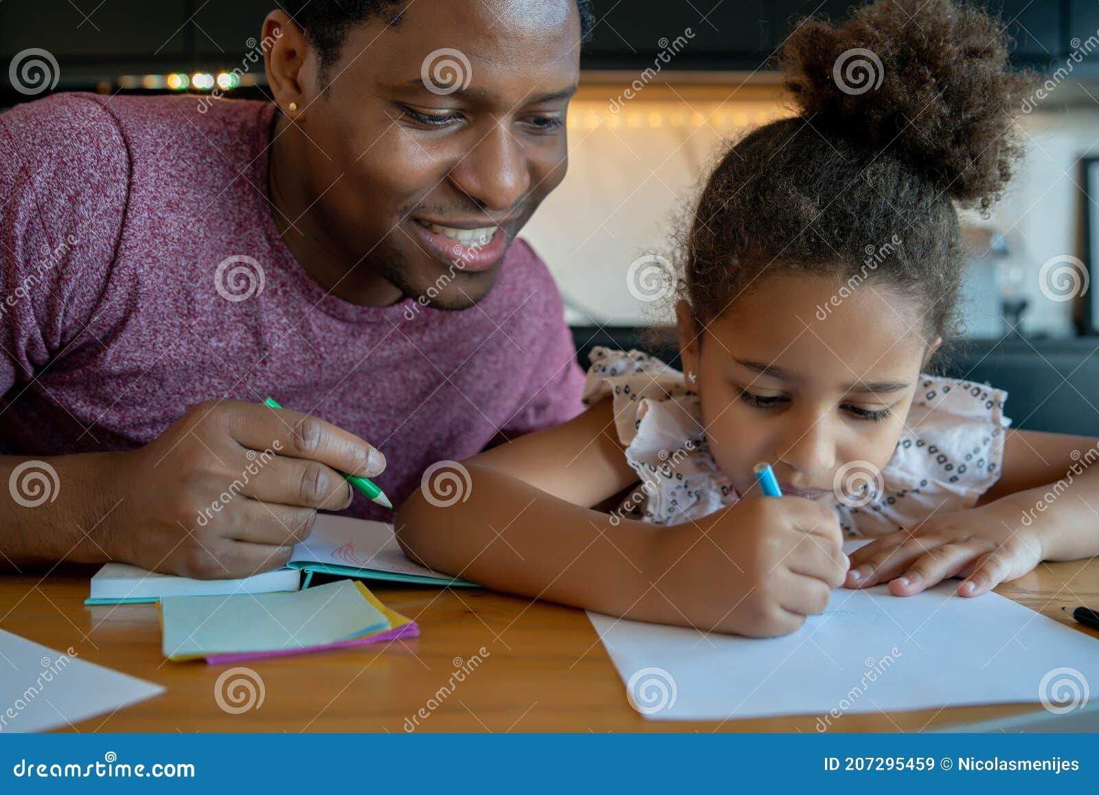 a father helping his daughter with homeschool.