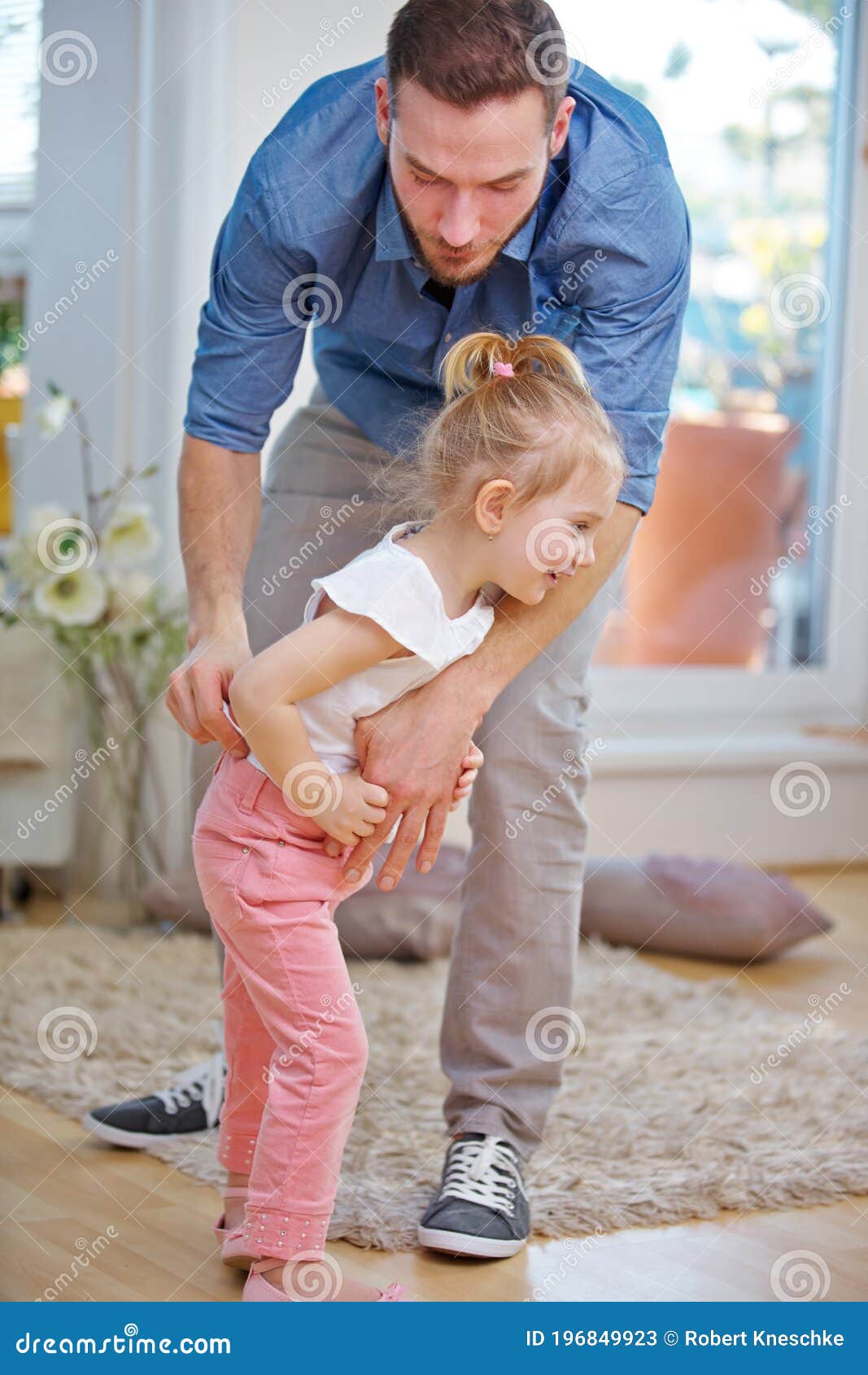 Father Helps Daughter Put on Pants Stock Image Image of joyful, father 196849923