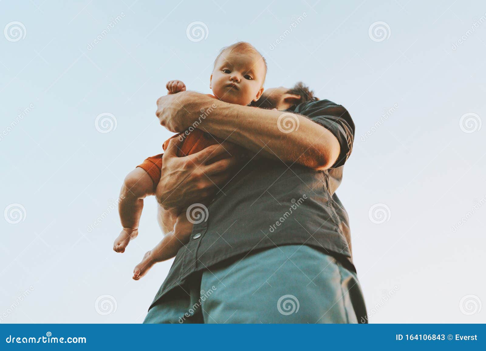 father holding infant baby family lifestyle dad and child